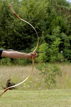 Man shooting with bow Stock Photos