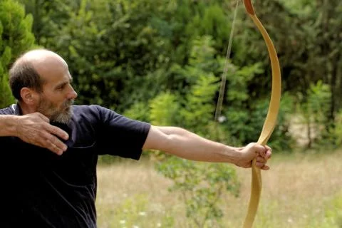 Man shooting with bow Stock Photos