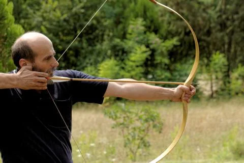 Man shooting with bow Stock Photos