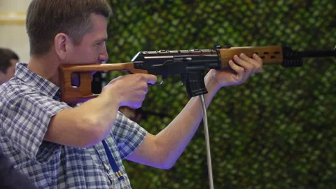 Man in shooting gallery Stock Footage 88435013