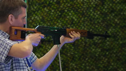 Man in shooting gallery Stock Footage 88681524