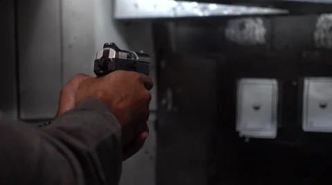 Man shooting a gun in a range Stock Footage 61584037