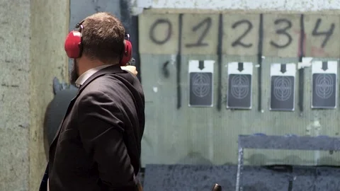 Man shooting with gun at target Stock Footage 144312536
