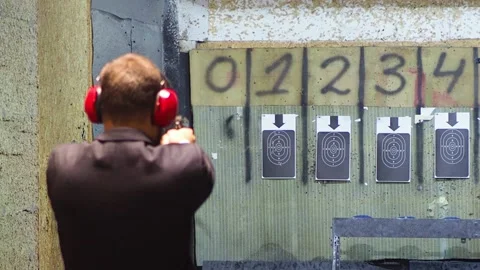 Man shooting with gun at target Stock Footage 144314635
