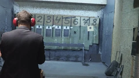 Man shooting with gun at target Stock Footage 144314730