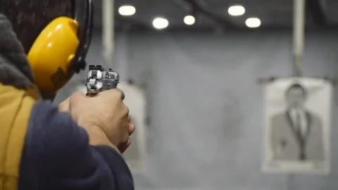 Man shooting with a pistol Stock Footage 72973790