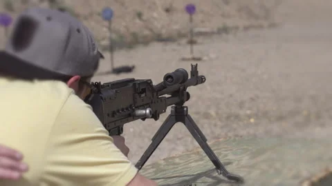 Man at shooting range firing machine gun Stock Footage 138906042
