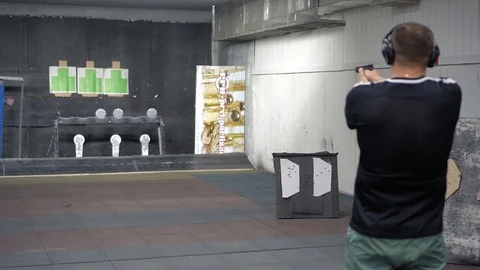 Man in shooting range in shooting action with GLOCK 19 Stock Footage 115184677