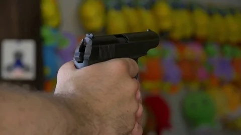 A man in a shooting range shoots a pneumatic pistol on the target in slow motion Stock-Footage 81794809