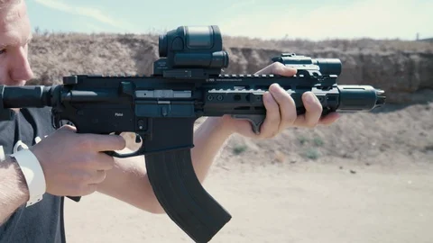 Man shooting rifle, slow motion, day Stock Footage 101736155