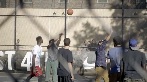 Man shooting scoring basket at West 4th Street basketball courts in NYC Stock Footage