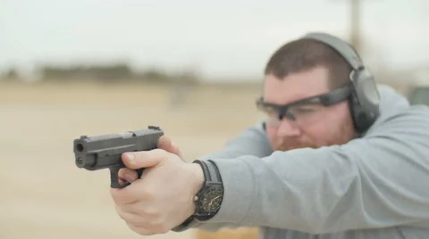 Man Shooting Semi Automatic Handgun at Gun Range Stock Footage 60665255
