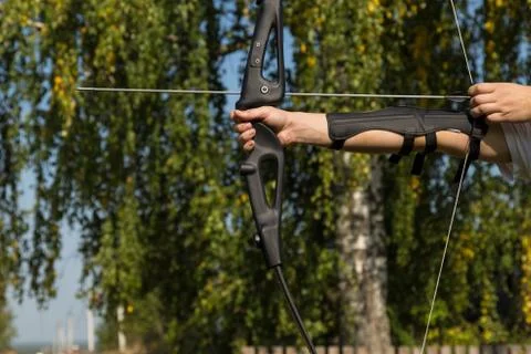 The man shoots from the bow. Close-up. Practice of archery Stock Photos