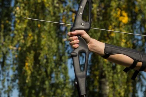 The man shoots from the bow. Close-up. Practice of archery Stock Photos
