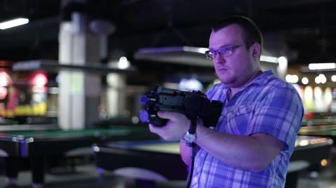 Man shoots from the gaming machine simulator Stock Footage 58199625