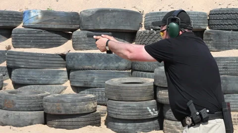 Man shoots a gun Stock Footage 30460464