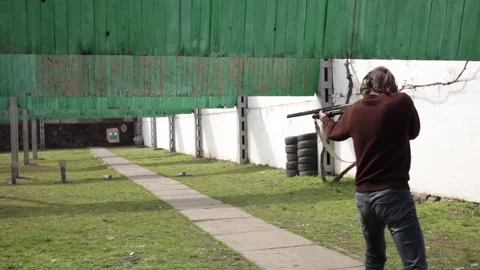 A man shoots a pump-action firearm Stock Footage 151968752