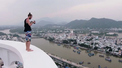 Man shoots something from a height Stock Footage 73351946