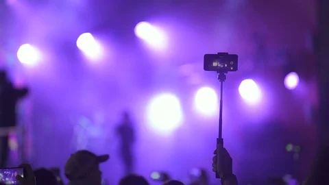 Man shoots video on his cell phone using a selfie stick Stock Footage