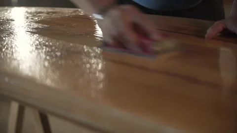 Man in the shop grinds the side of the surf Board Stock Footage 132981646