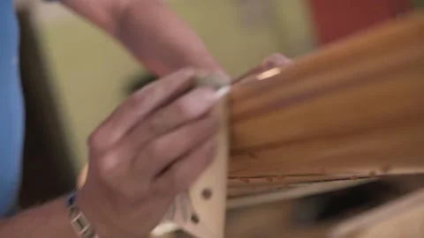 Man in the shop grinds the side of the surf Board Stock Footage 133022889