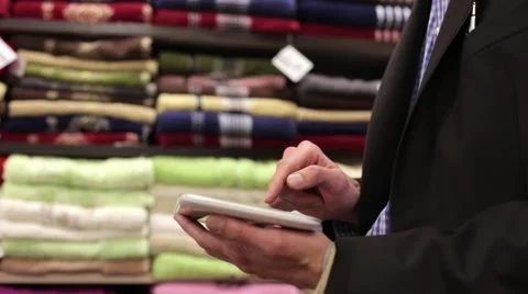 The man in the shop makes a purchase using a tablet Stock Footage 59319385