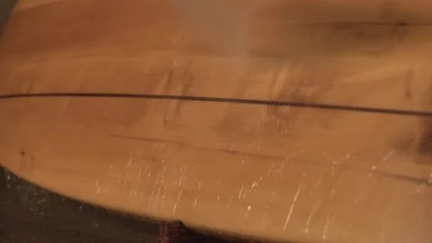 Man in the shop washes the surface of the surf Board Stock Footage 133026172