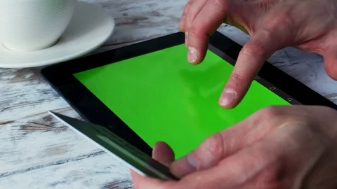 Man is shoping online in cafe with tablet empty green screen. 4k Video stock 71377334