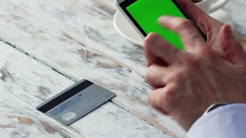 Man is shoping online with green screen Smart Phone in cafe, 4k close up Video stock 71376939