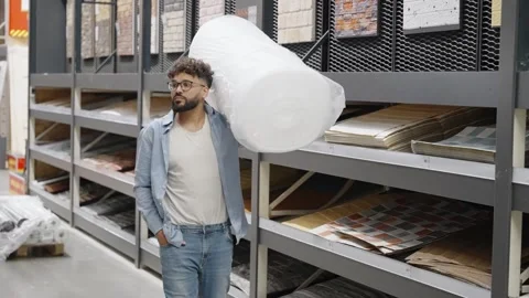 Man shopping for floor underlay at a hardware store Stock Footage 336965203