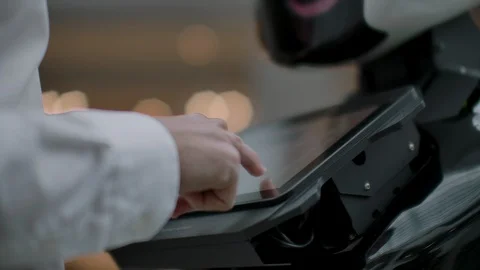 The man in the shopping Mall communicate with a robot Advisor. Modern shop and Stock Footage 113798876