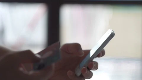 Man Shopping Online Using His Mobile Phone, Putting Credit Card Details Stock Footage 91825183