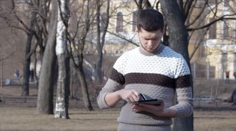 Man shopping online using tablet and credit card outside Stock Footage 61865185
