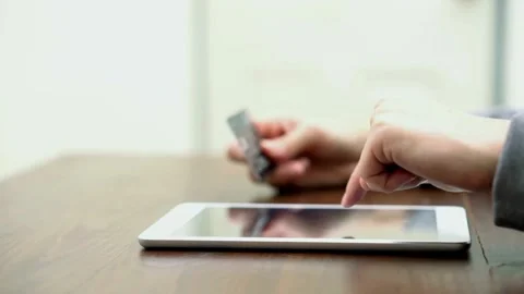 Man shopping online using tablet home tab and credit card Smiling customer Stock Footage 265932258