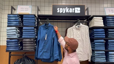 A man shopping at a stylish Spykar store Stock Video Pond5
