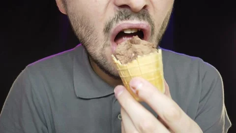 A man with a short beard eats ice cream in a cup, close-up Video stock 132092843