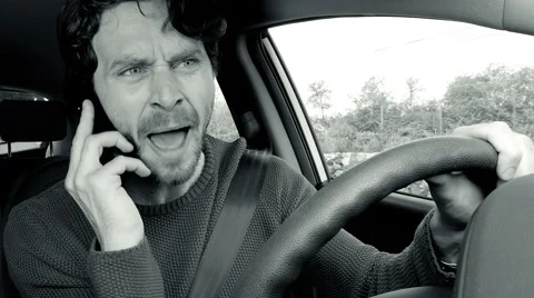 Man shouting and yelling angry talking on the phone while driving car 4K blac Stock Footage