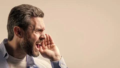 Man with shouting face isolated on studio background, copy sace banner. man with Stock Photos