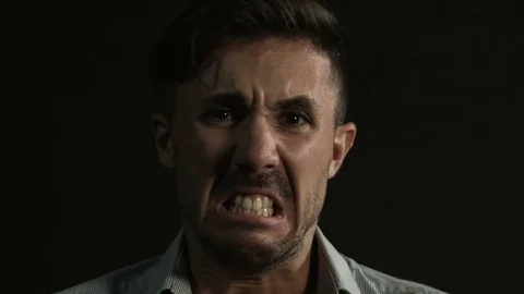 Man shouting looking camera, slowmotion. Black background Video stock 80303571