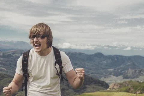 Man shouting at the mountain top Stock Photos