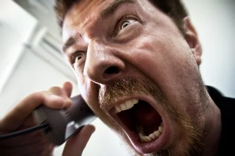 Man shouting at telephone Stock Photos