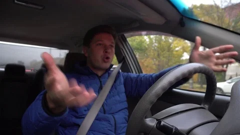 A man is shouting at the wheel of a car. Stock Footage 81232962