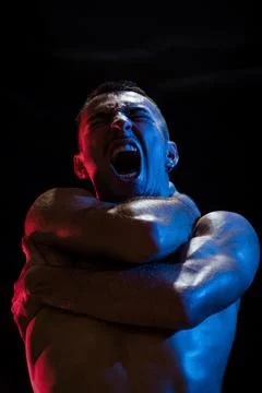 Man shouting while covering chest and neck with crossed arms Stock Photos