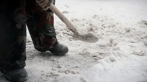 Man shoveling the snow from the path. Slow motion Stock Footage 100980000