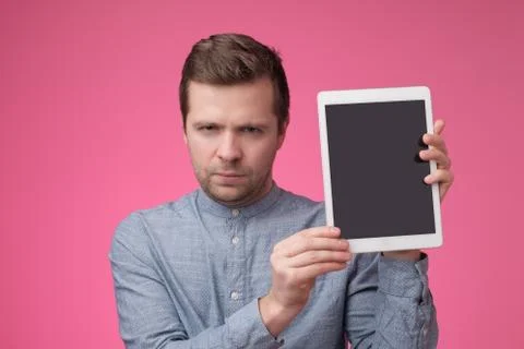 Man show with the blank screen of tablet and finger point up Stock Photos