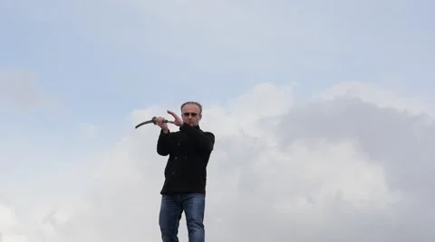 Man  show techniques with a sword time lapse with moving clouds Stock Footage 48686839