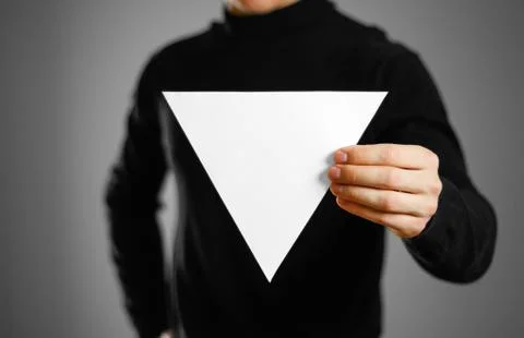 Man showing blank triangular white paper. Leaflet presentation. Pamphlet hold Foto stock