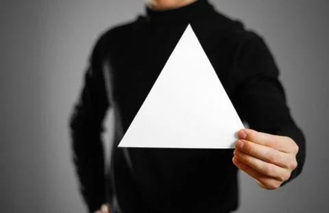 Man showing blank triangular white paper. Leaflet presentation. Pamphlet hold Foto stock