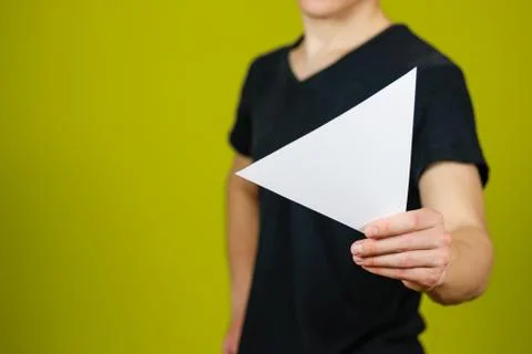 Man showing blank white triangular flyer brochure booklet. Leaflet presenta.. Fotos de archivo