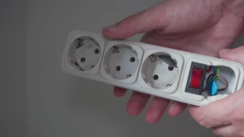 Man showing a broken power strip with exposed wires Stock Footage 343736713